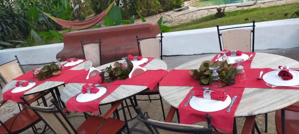 Tables set outdoors for small dinner party, Laguna Anjuna